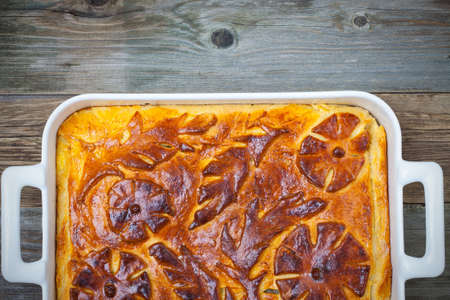 turnover in a white ceramic pot on vintage tableの写真素材