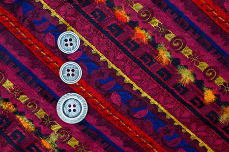 vintage varicolored tape with embroidered ornaments and three old silver buttonsの写真素材