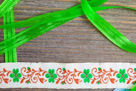 vintage embroidered band and green tape on antique textured boardの写真素材