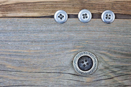 vintage classic buttons on the aged textured boards of the old tailor tableの写真素材