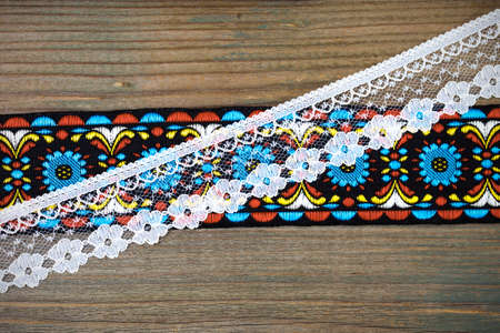 vintage ribbons and lace on the aged textured boards