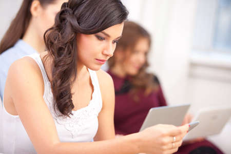 young girl reading tablet at campus