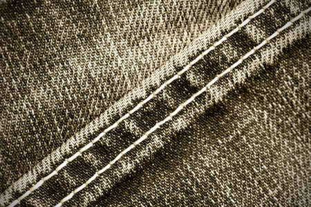 part of old jeans background with diagonal seams. monochrome imageの写真素材