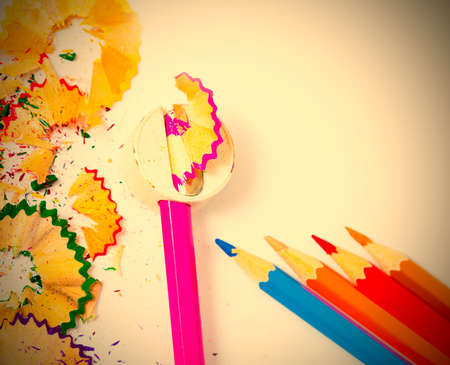 set of colored pencils, sharpener and shavings on white background with copy space. instagram image...
