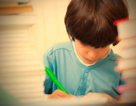schoolboy doing homework in the library. copy space. retro style