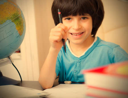 smiling schoolboy doing homework. retro style