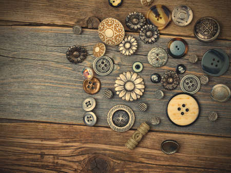 still life with vintage buttons on the aged wooden boards. retro styleの写真素材