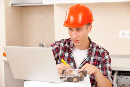 Engineer calculates estimates for repair in a interior of new apartment