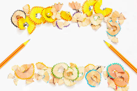 two striped pencils and colored shavings on white backgroundの写真素材