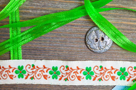 vintage embroidered band and tape with old classic button on antique textured boardの写真素材