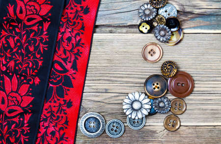 colored ribbons, and vintage buttons on the old tailoring tableの写真素材