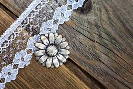 vintage button and lace tape on old wooden surfaceの写真素材