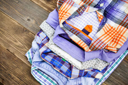 colorful shirts on antique wooden shelf in a store