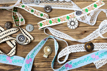vintage buttons, lace, tape and ribbons on the old tailoring table