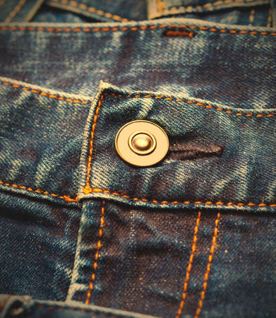 part of blue jeans with button, close up. image retro styleの写真素材