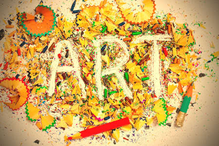 Art word on the background of colored pencil shavings on the white.の写真素材