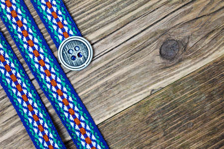 vintage varicolored ribbon with embroidered ornament and old buttonの写真素材