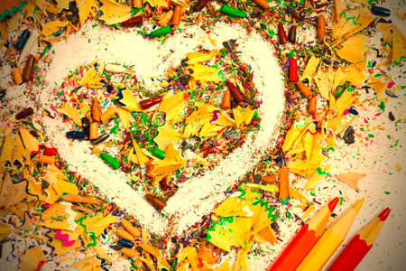 heart, multicolored pencils and varicolored wooden shavings close up.の写真素材