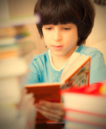 boy reading a book in the library.