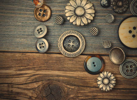 Set of retro buttons on aged wooden table.の写真素材