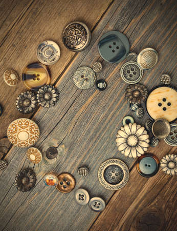 vintage buttons on old wooden boards.の写真素材