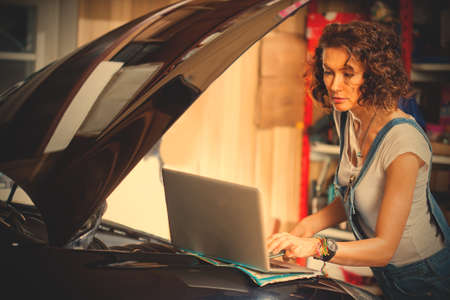 mechanic diagnoses the car engine works. preparing to travel. fashion. technologies.