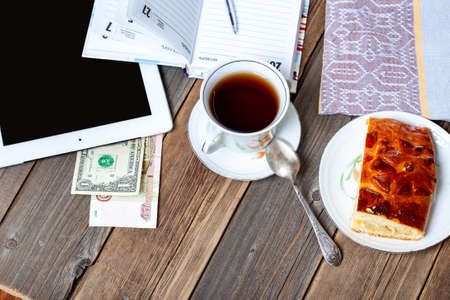 Businessman breakfast with tea and cakeの写真素材