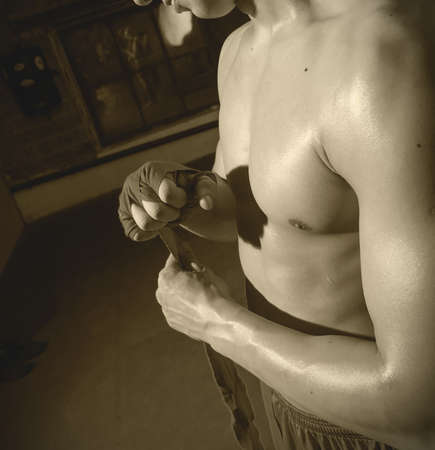 boxer wraps his hand a red bandage before the fight