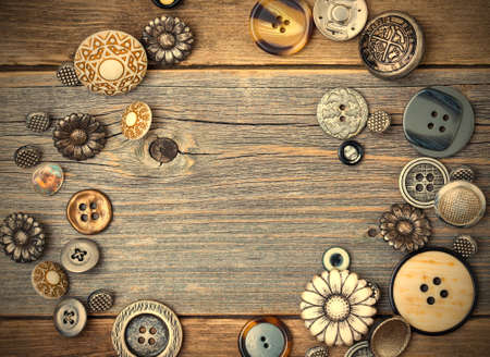 several old buttons on the vintage table surface with copy space.の写真素材