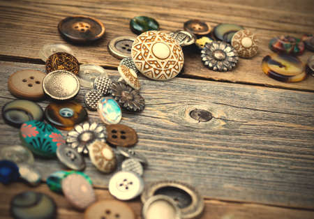 placer of old buttons with copy space on surface of old table.
