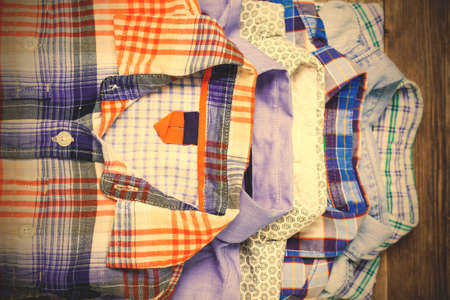shirts in pile on old textured wood boards.の写真素材
