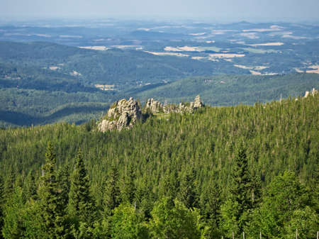 Panoramic view on Karkonoski National Park from the Giant Mountains peak. Green woods and granite rock formation in bright sunny day.の写真素材