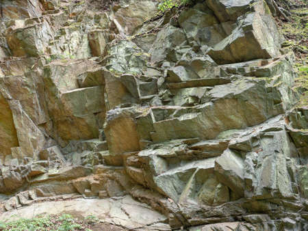 Natural variegated rocks of sandstone. Details of stone texture background.の写真素材