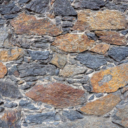 Details of the natural old stonewall, usable for the background or texture. Close-up of old rocks used for fortification wall.の写真素材