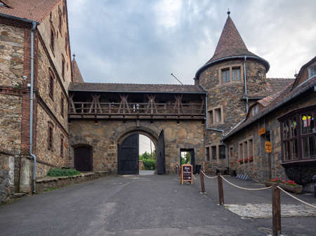 Czocha, Poland-August 25, 2019: View on main gate and outer bastion from the inside of castle bailey. Visible tourist bar and the ticket sales point.のeditorial素材