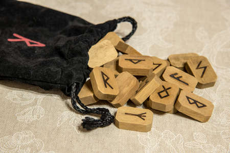Wooden runes with black bag. Esoteric subjects.の写真素材