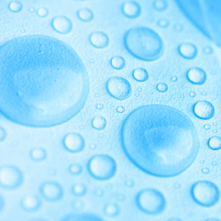 Blue drops of water on the textured surfaceの写真素材