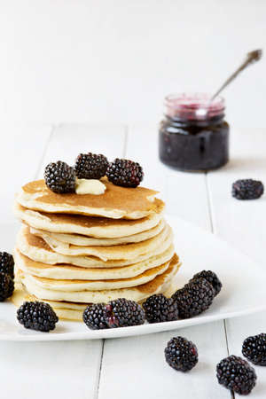 Stack of old-fashioned american pancakes with blackberry and jamの写真素材