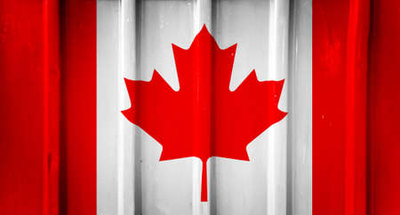 Grunge canadian flag background painted on the metal fenceの写真素材