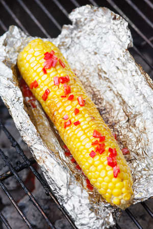 Corn grilled with lime juice, butter and chiliの写真素材