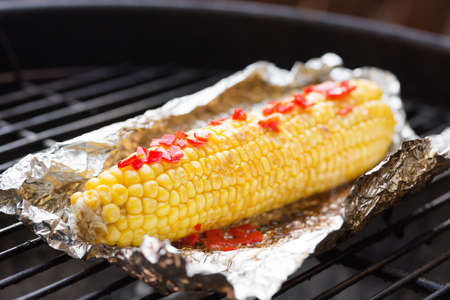 Corn grilled with lime juice, butter and chiliの写真素材