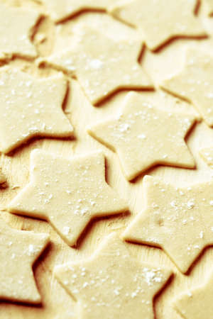 Christmas star cookie on the wooden table ready for bakingの写真素材