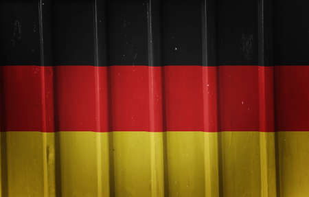 Grunge german flag background painted on the metal fenceの写真素材