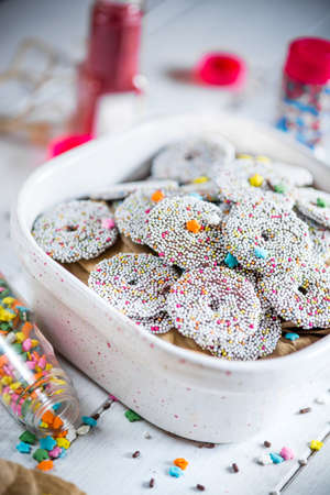 Bowl of sprinkled holiday cookies on a party tableの写真素材
