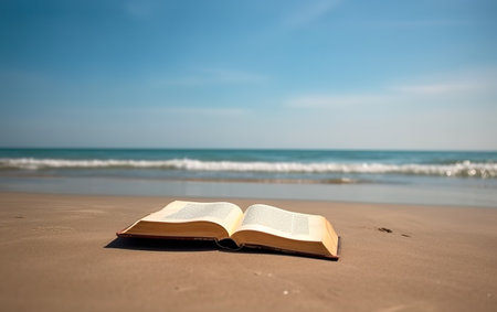 Open book on the beach with blue sky and sea in the backgroundの素材