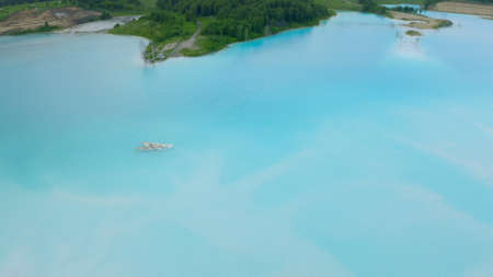 Artificial lake for discharging chemical waste from a chemical plant. Environmental pollution. Ecological catastrophy. Aerial shot . Beautiful view.の写真素材