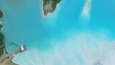 Artificial lake for discharging chemical waste from a chemical plant. Environmental pollution. Ecological catastrophy. Aerial shot . Beautiful view.の写真素材