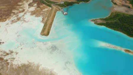 Artificial lake for discharging chemical waste from a chemical plant. Environmental pollution. Ecological catastrophy. Aerial shot . Beautiful view.の写真素材