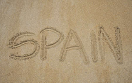 The written word spain in the beach sand.の写真素材