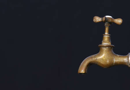 Old tap with black blackground.の写真素材
